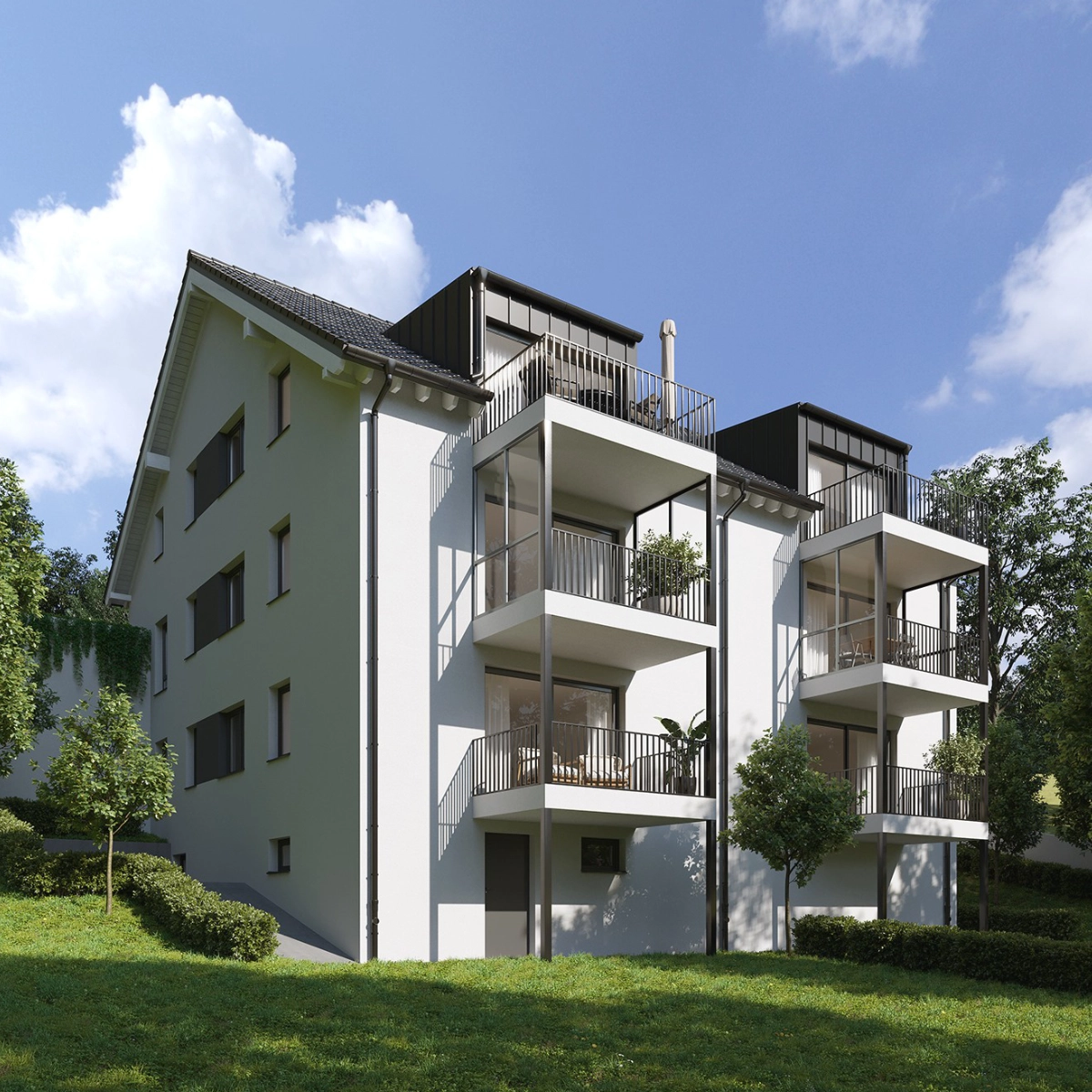 Neubau eines Mehrfamilienhauses mit Balkonen, umgeben von Gr&uuml;n